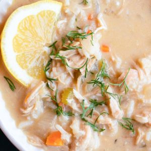 close, overhead image of greek lemon rice soup in white bowl