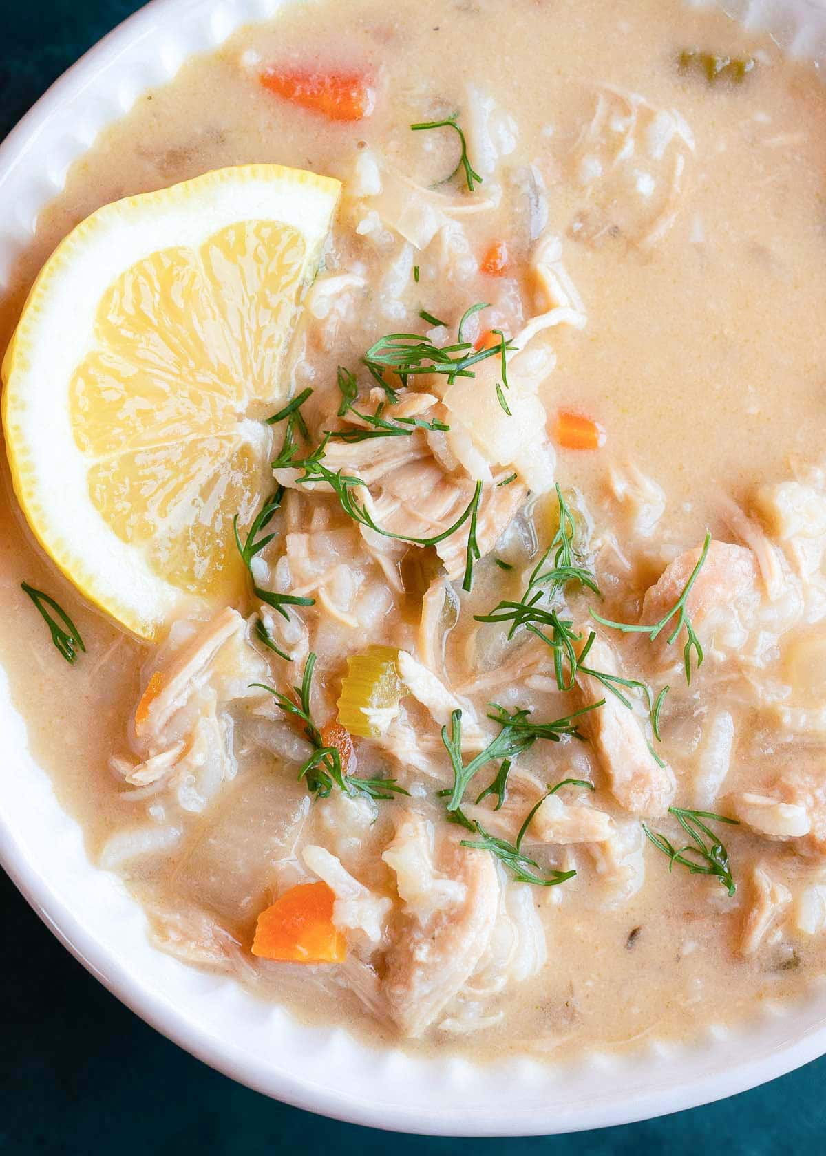 close, overhead image of greek lemon rice soup in white bowl