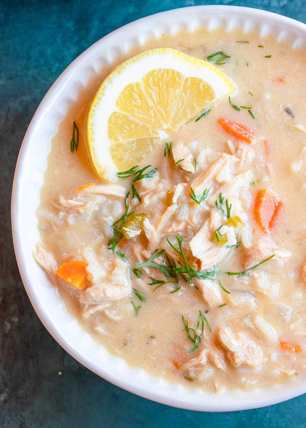 close up, overhead image of avgolemono soup in white bowl