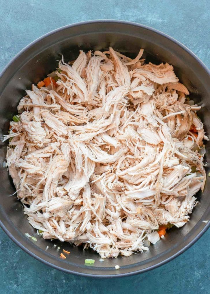 shredded chicken and vegetables in dutch oven