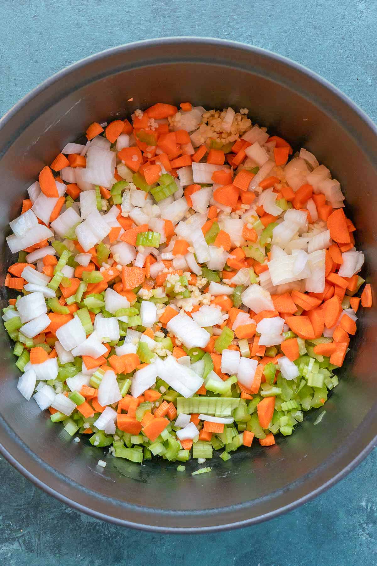 overhead image of vegetables being sauteed in dutch oven