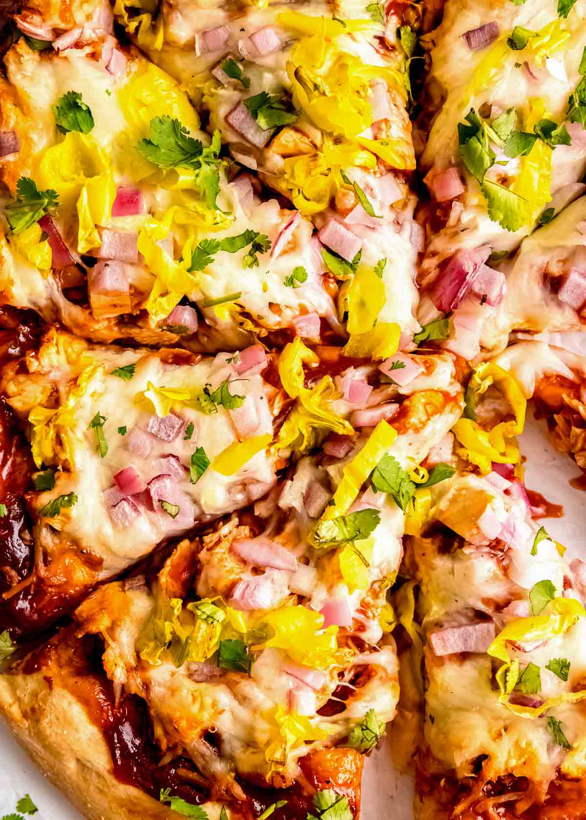 close up image of sliced bbq chicken pizza