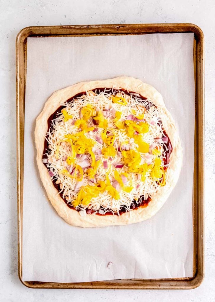 uncooked bbq chicken pizza on sheet pan