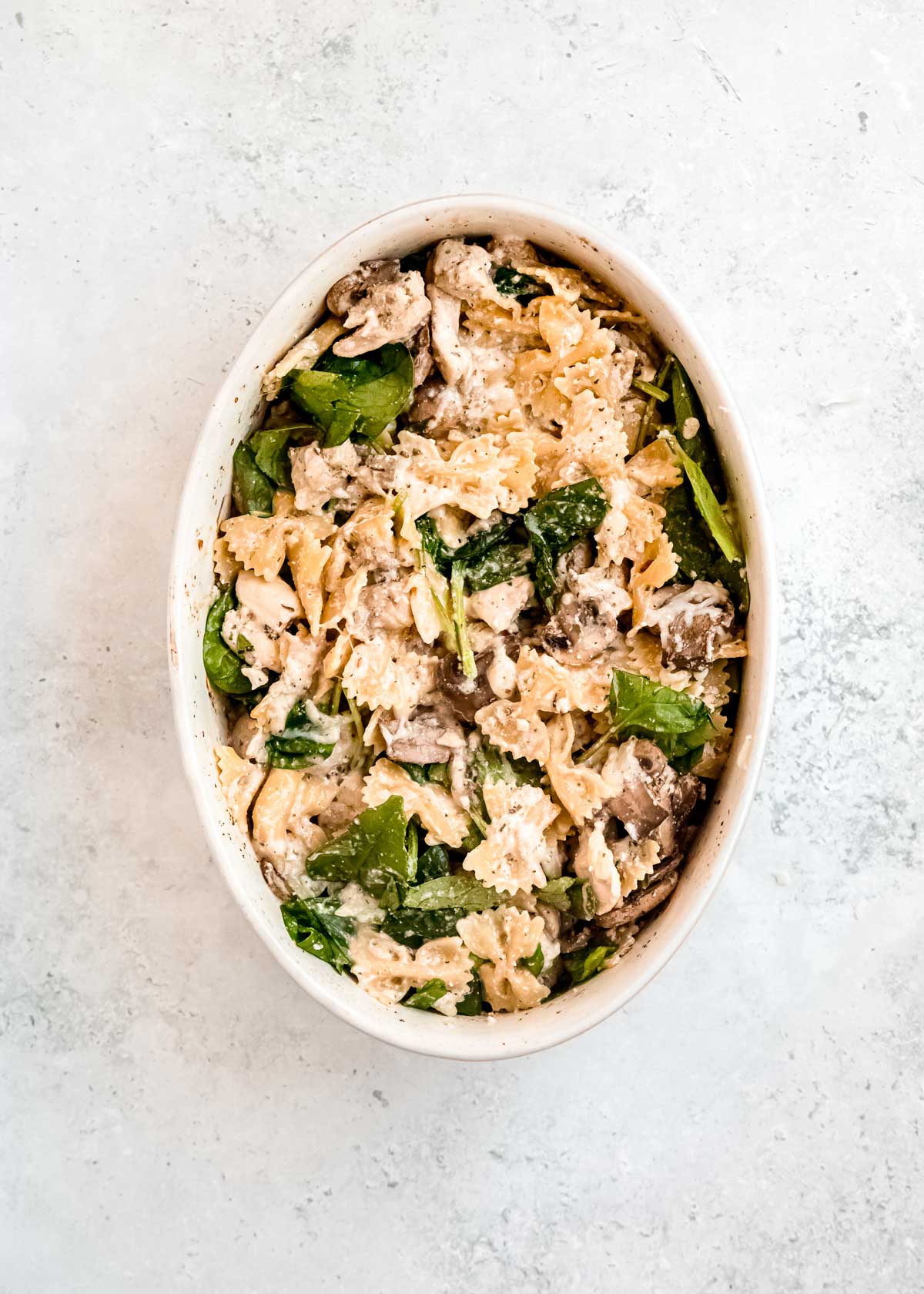 overhead image of baked chicken and mushroom pasta