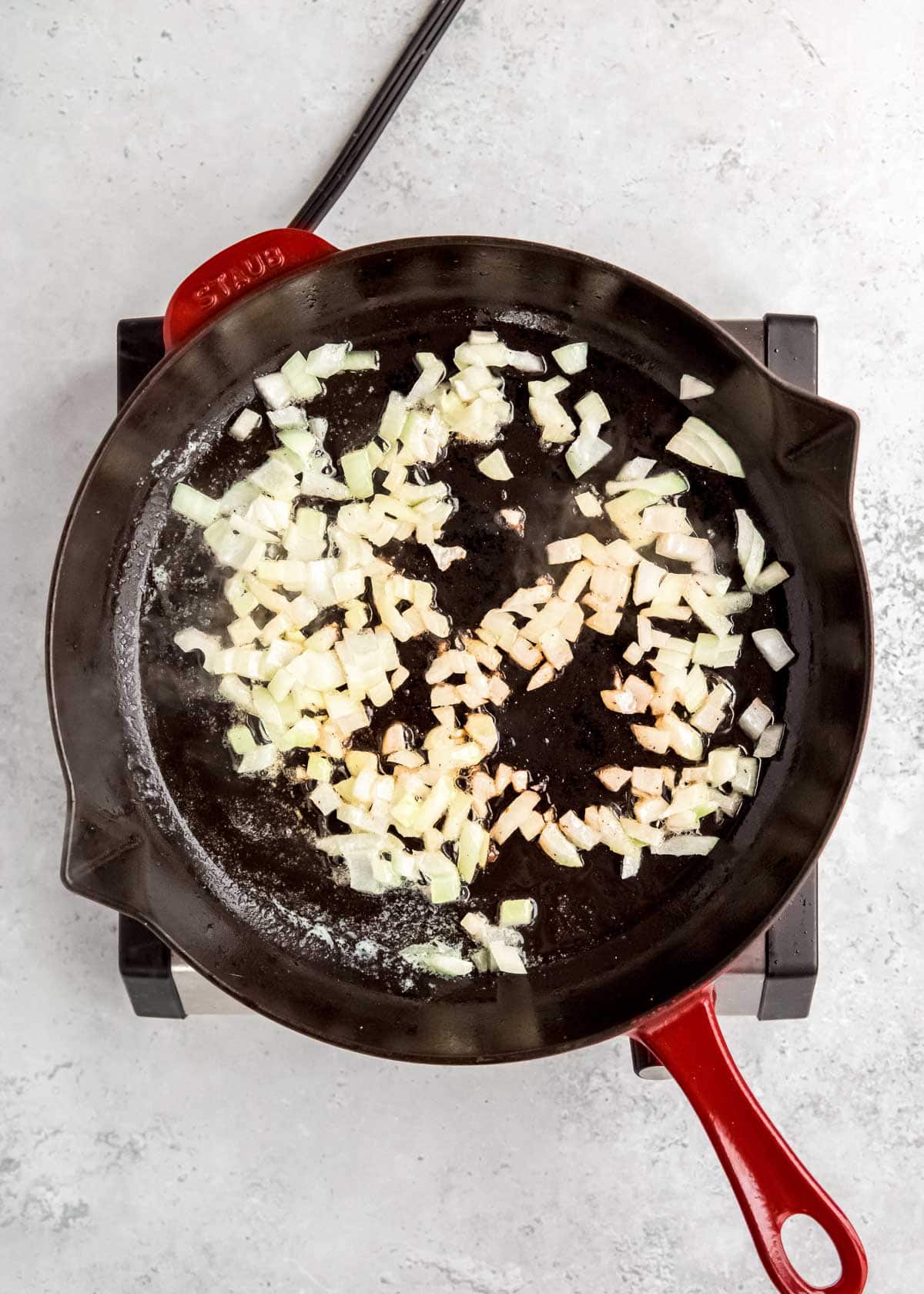 overhead image of onions being sauteed in skillet