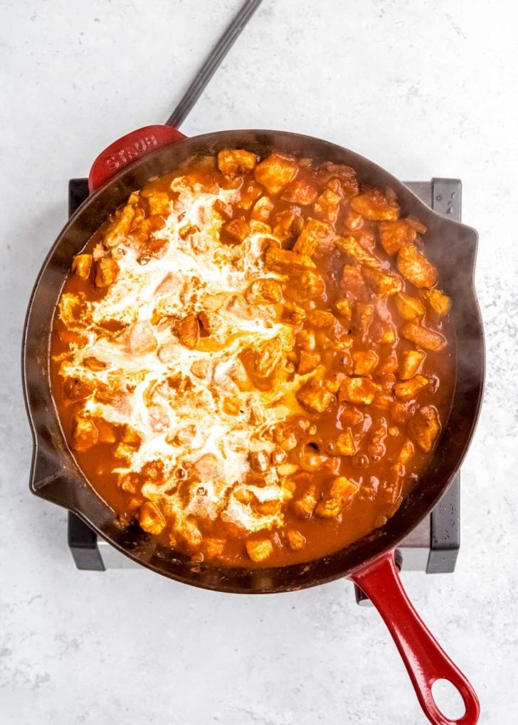 yogurt being added to butter chicken