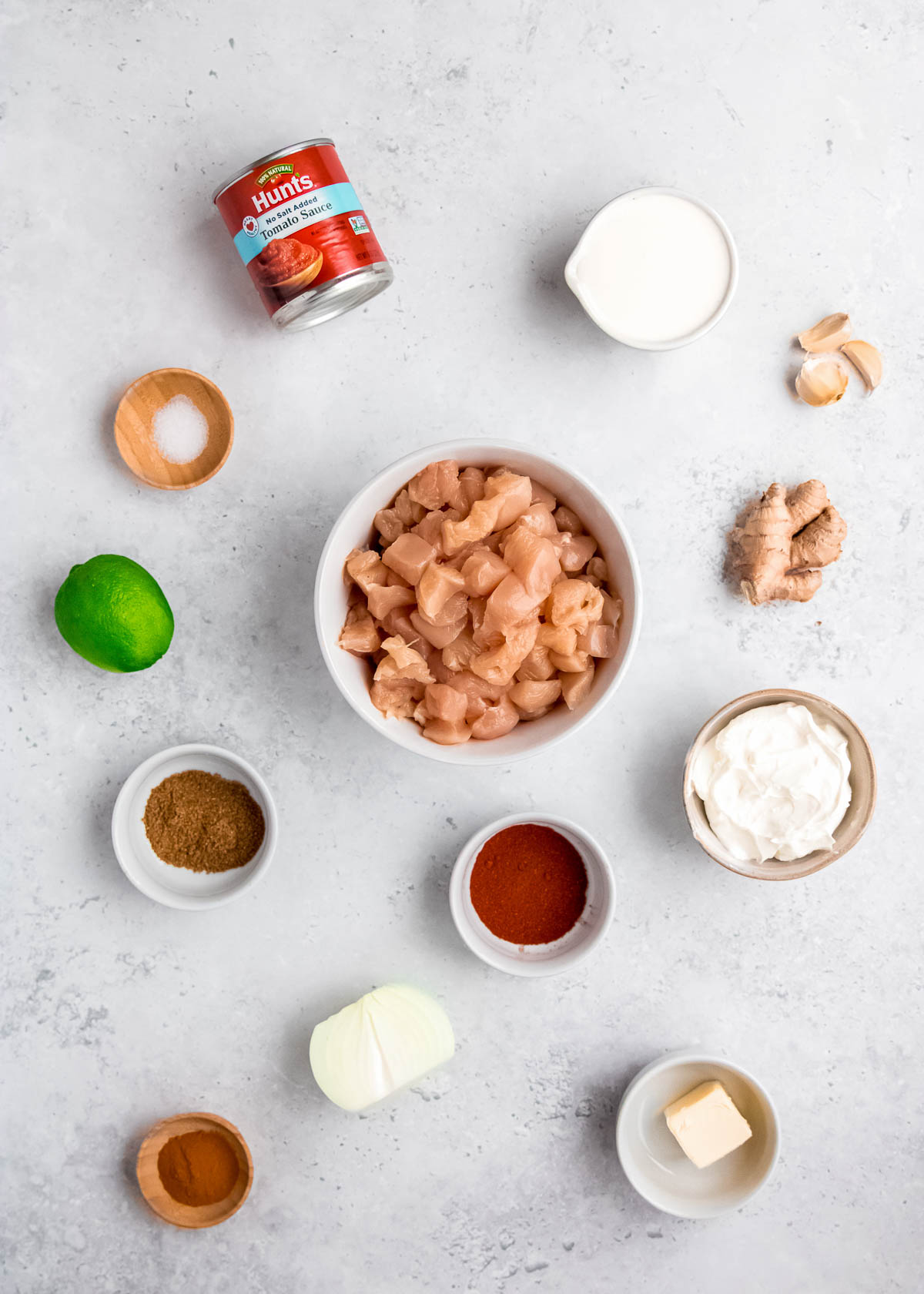 butter chicken ingredients on a white table