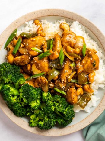 overhead image of cashew chicken and rice on a white table