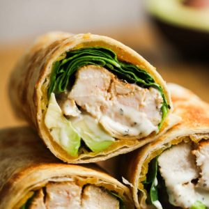 close up image of three chicken avocado wraps