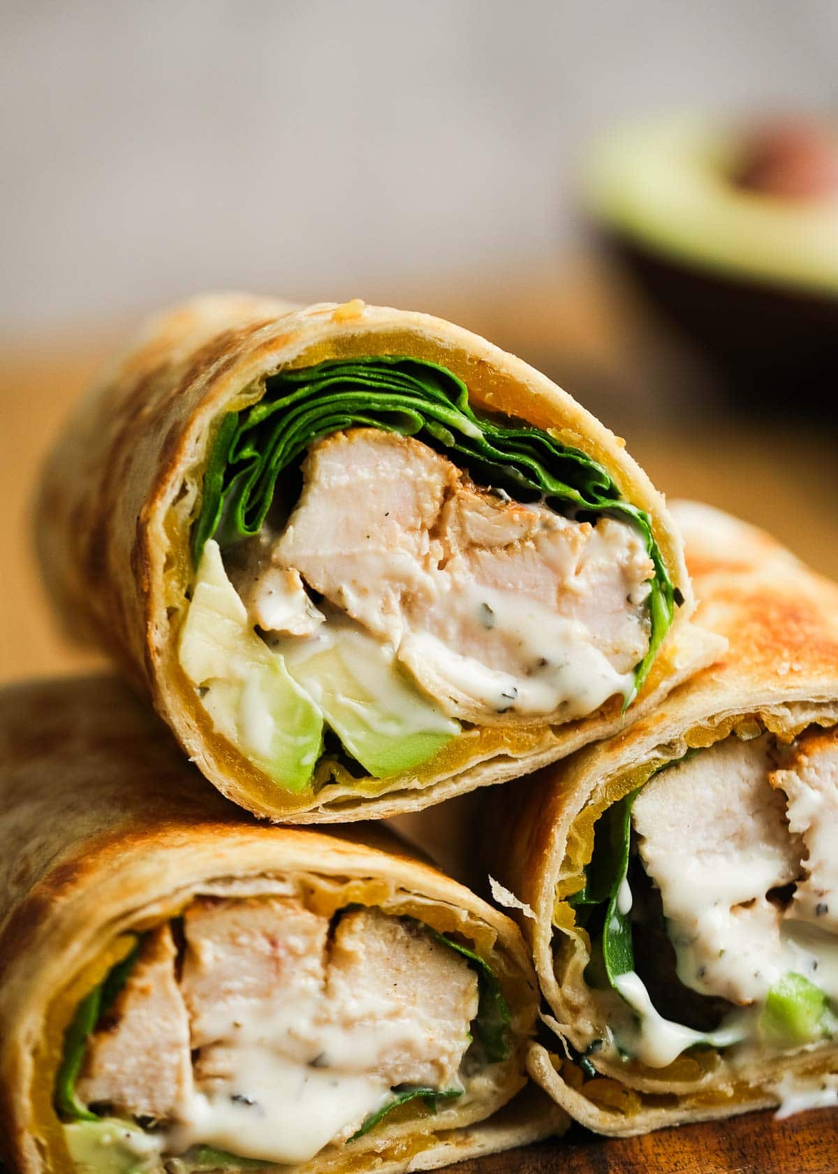 close up image of three chicken avocado wraps 