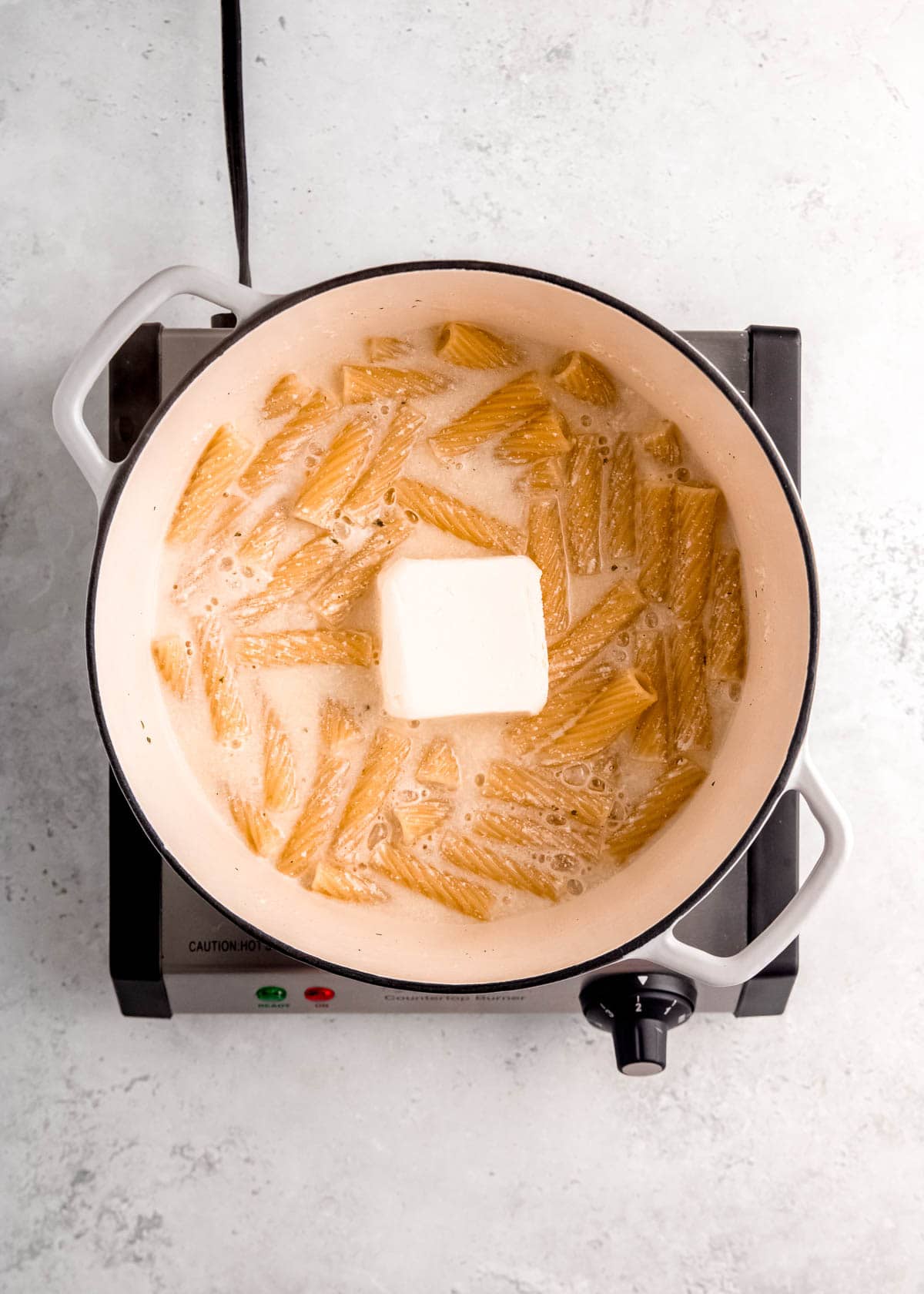 cream cheese being added to dutch oven