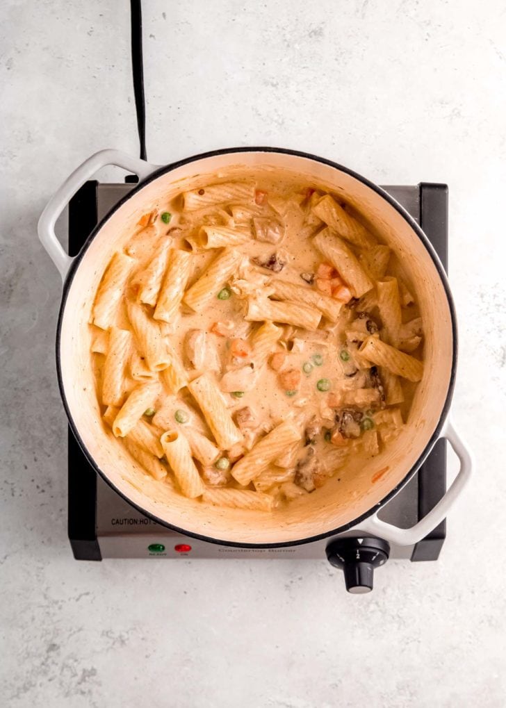 overhead image of chicken bacon ranch pasta ingredients after being stirred together in a dutch oven