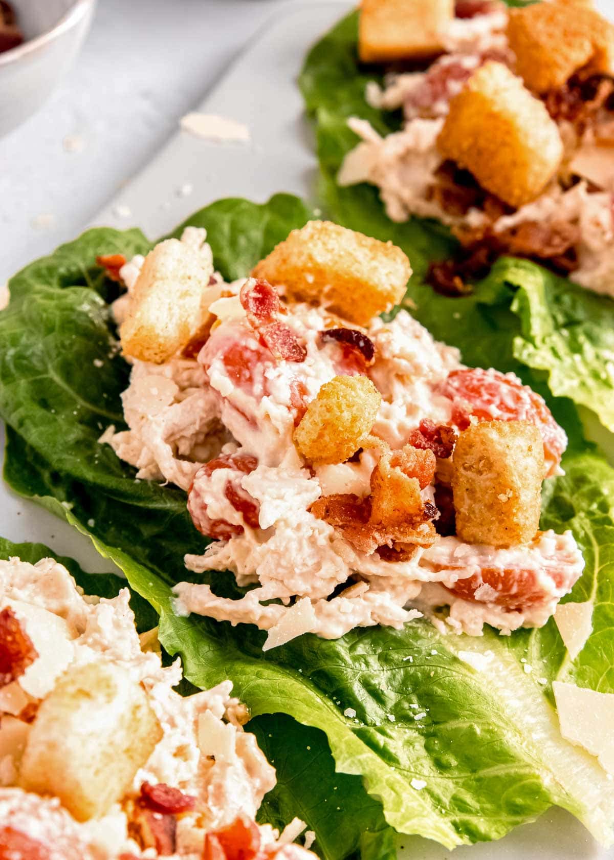 close up image of caesar salad lettuce wrap on cutting board