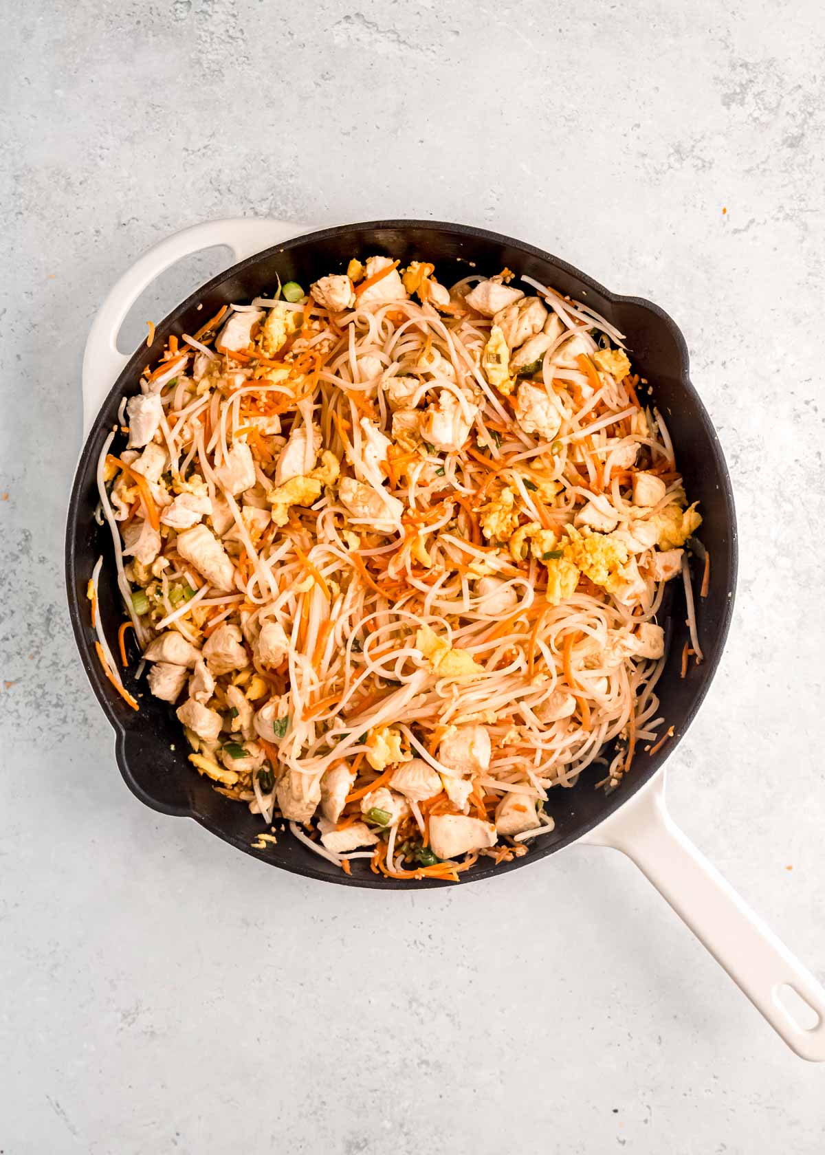 overhead image of chicken pad thai after sauce is added