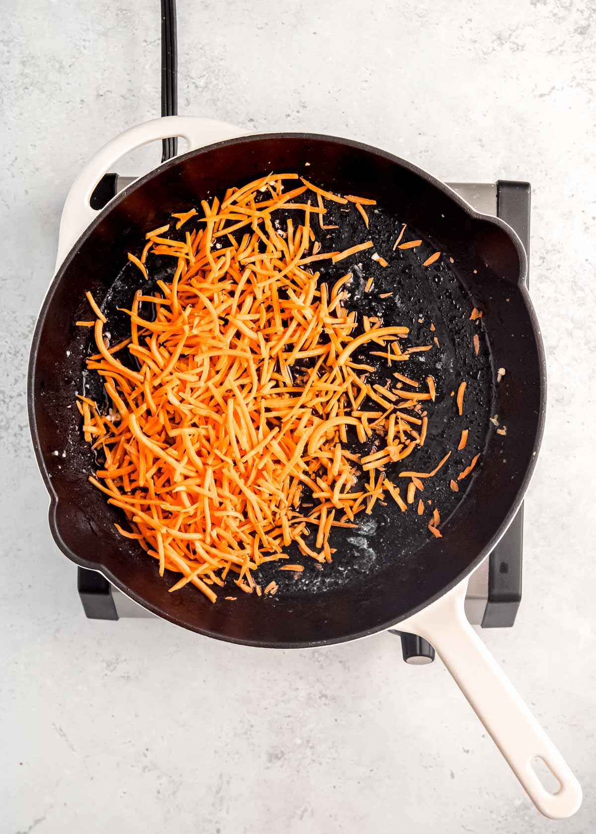 carrots being sauteed in skillet