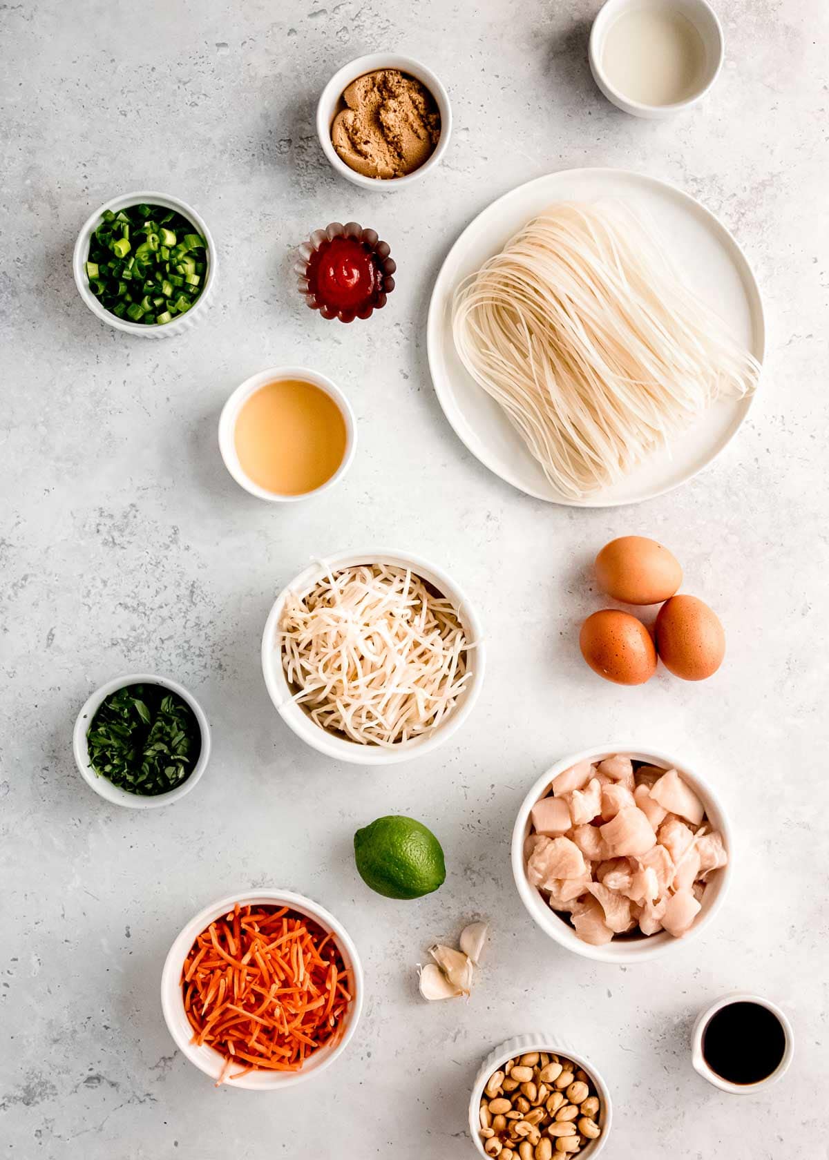 chicken pad thai ingredients on a white table 