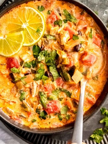 close up image of chicken poblano soup and spoon in black bowl