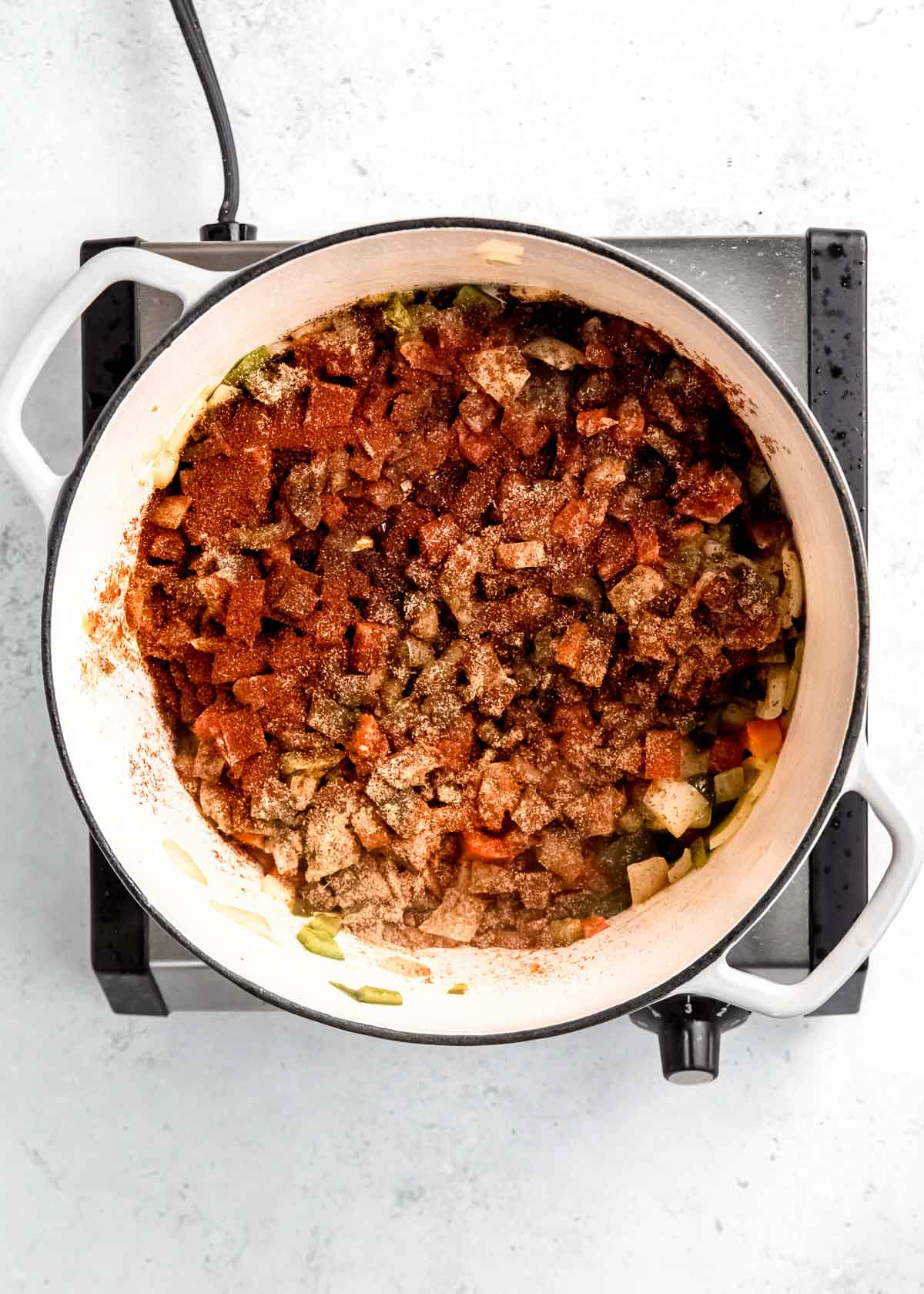 spices covering vegetables in dutch oven