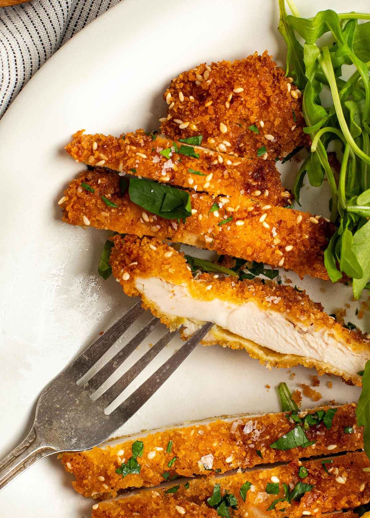 close up image of sliced chicken schnitzel