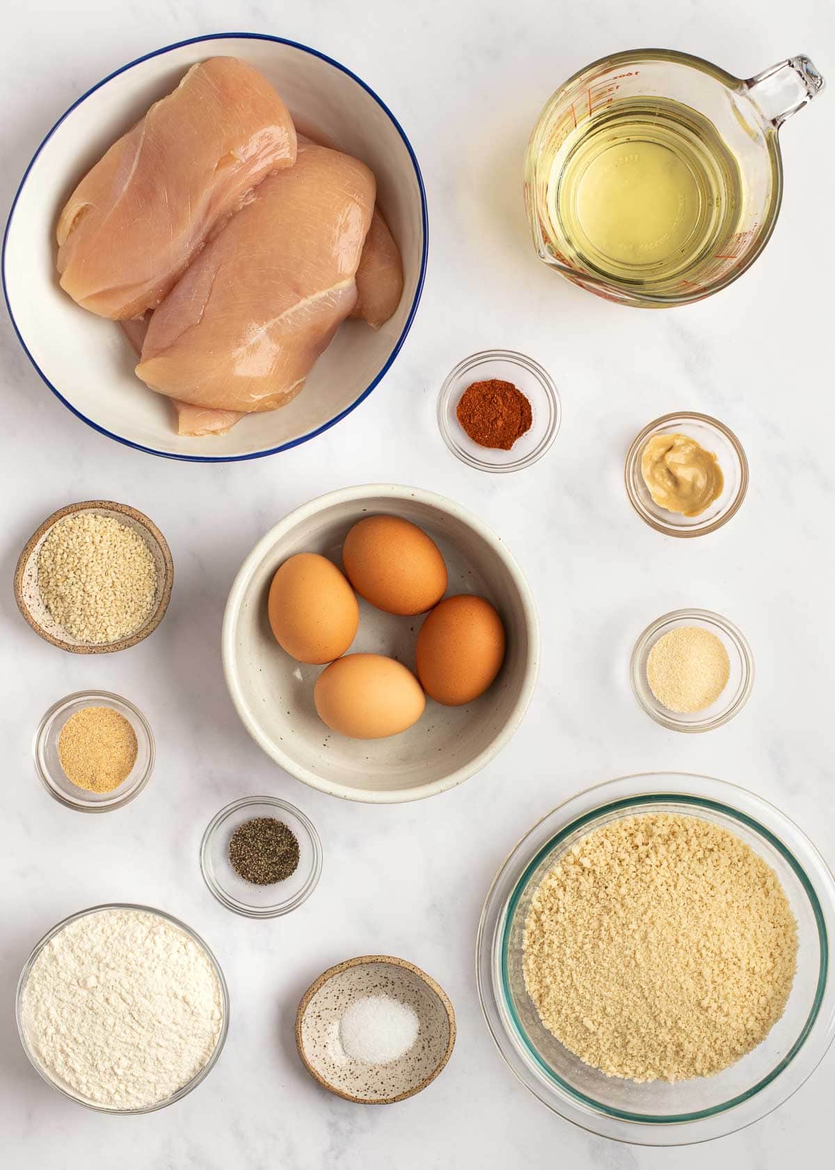 chicken schnitzel ingredients on a white table