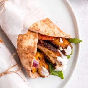 chicken shawarma on a white plate on white table