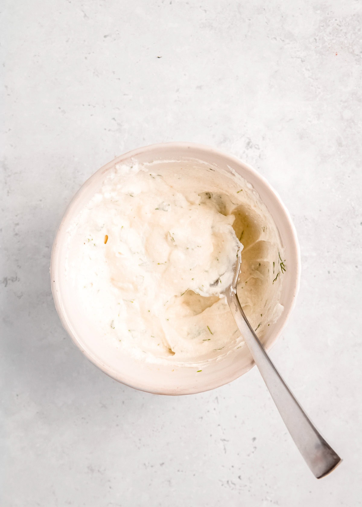 yogurt sauce after being mixed in white bowl