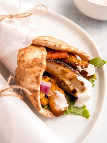 close up image of chicken shawarma on white plate