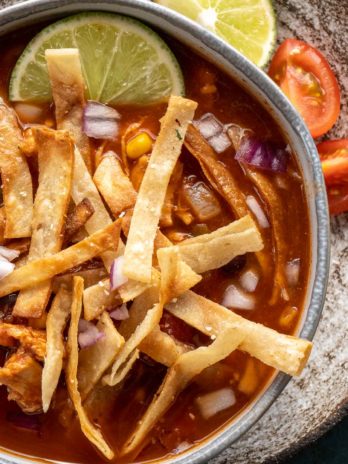 close up image of chicken tortilla soup in gray bowl