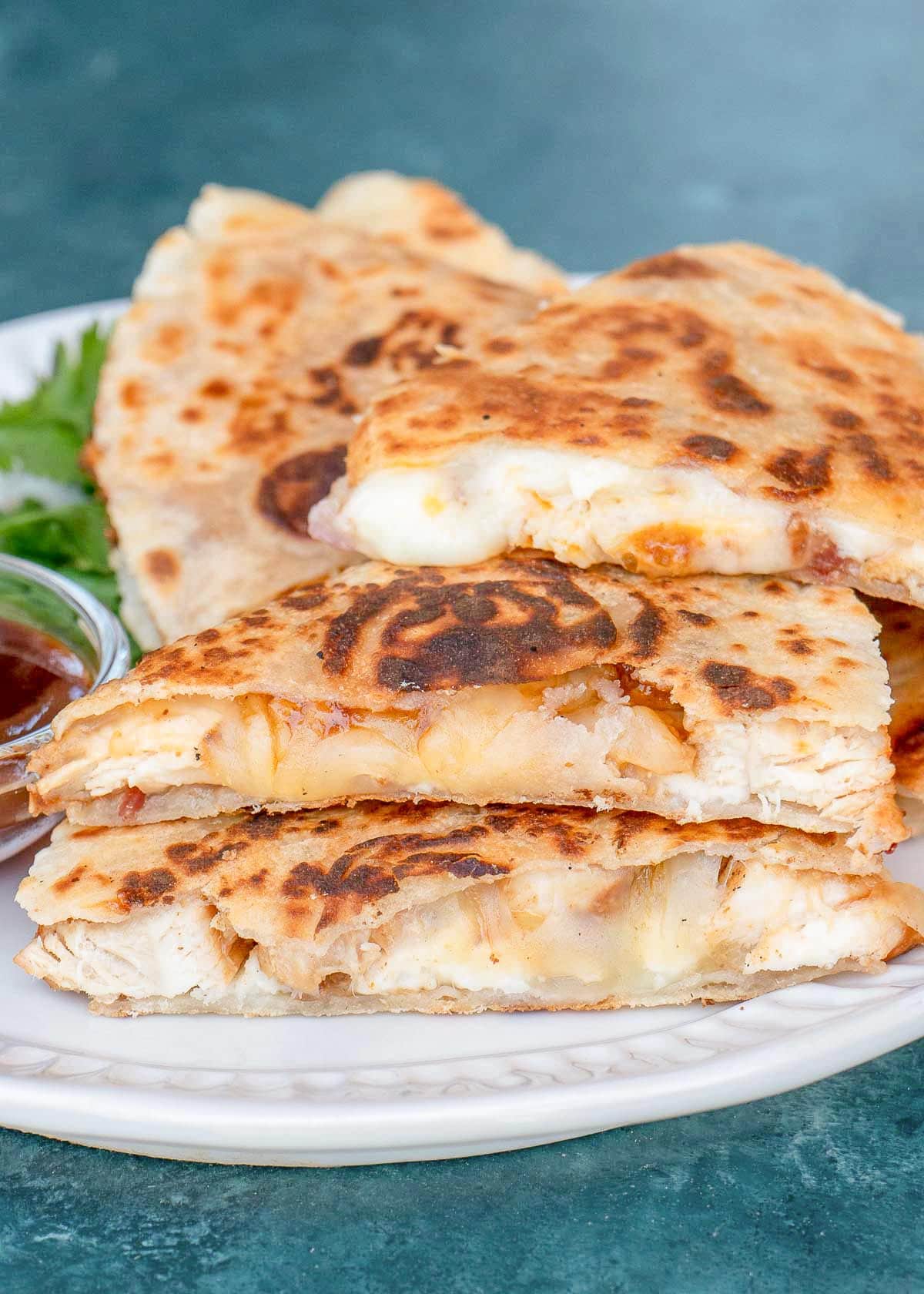 easy cheesy quesadilla stuffed with bbq chicken on a white plate