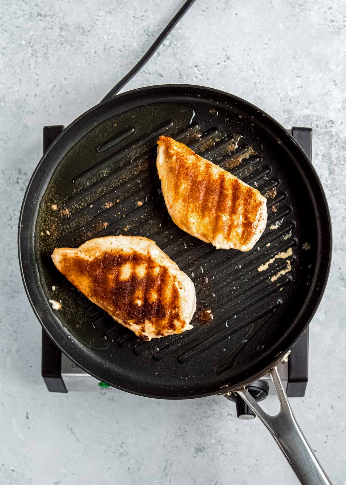 chicken being grilled in grill pan