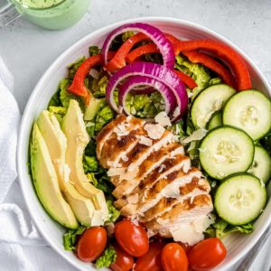 overhead image of green goddess salad on white plate