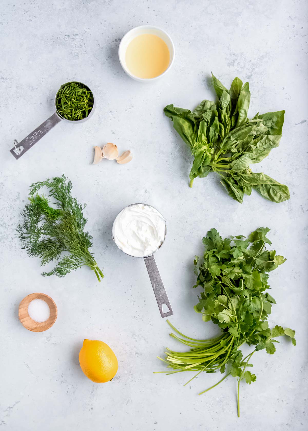 green goddess dressing ingredients on a white table