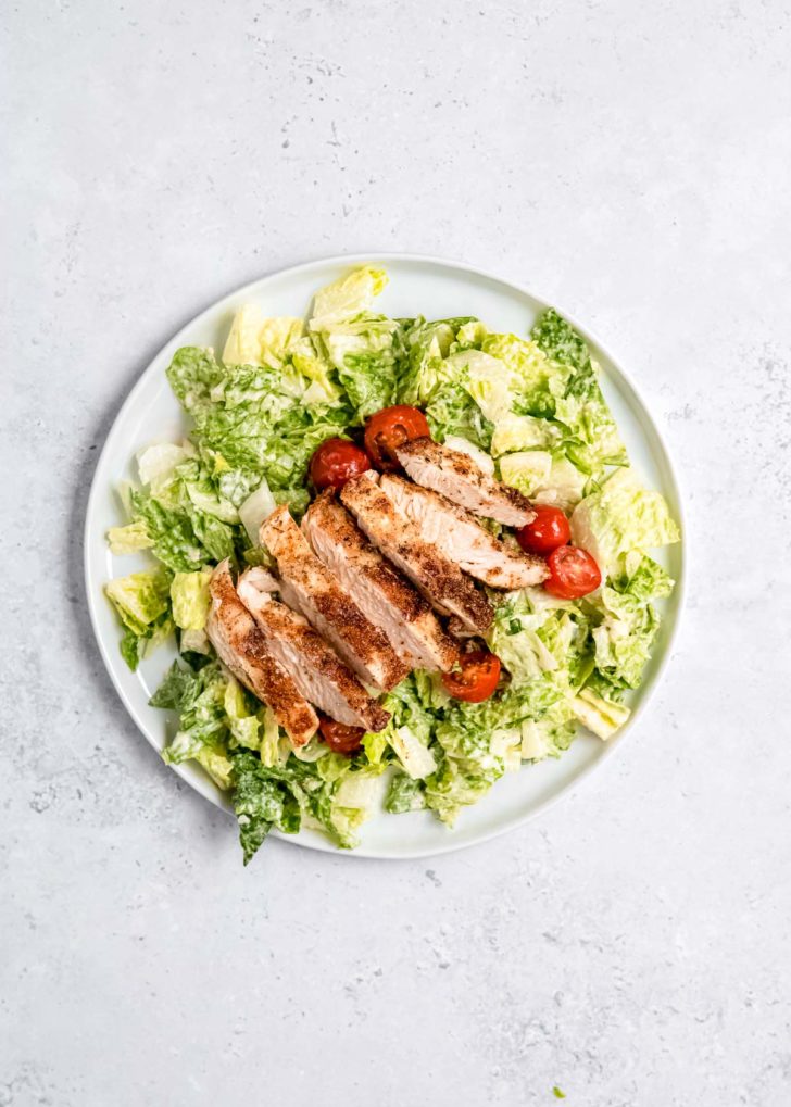 grilled chicken caesar salad on a plate