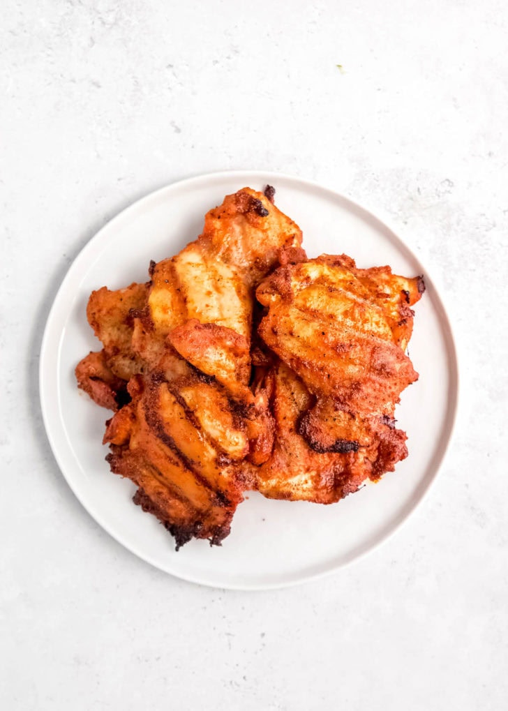 grilled chicken stacked on white plate 