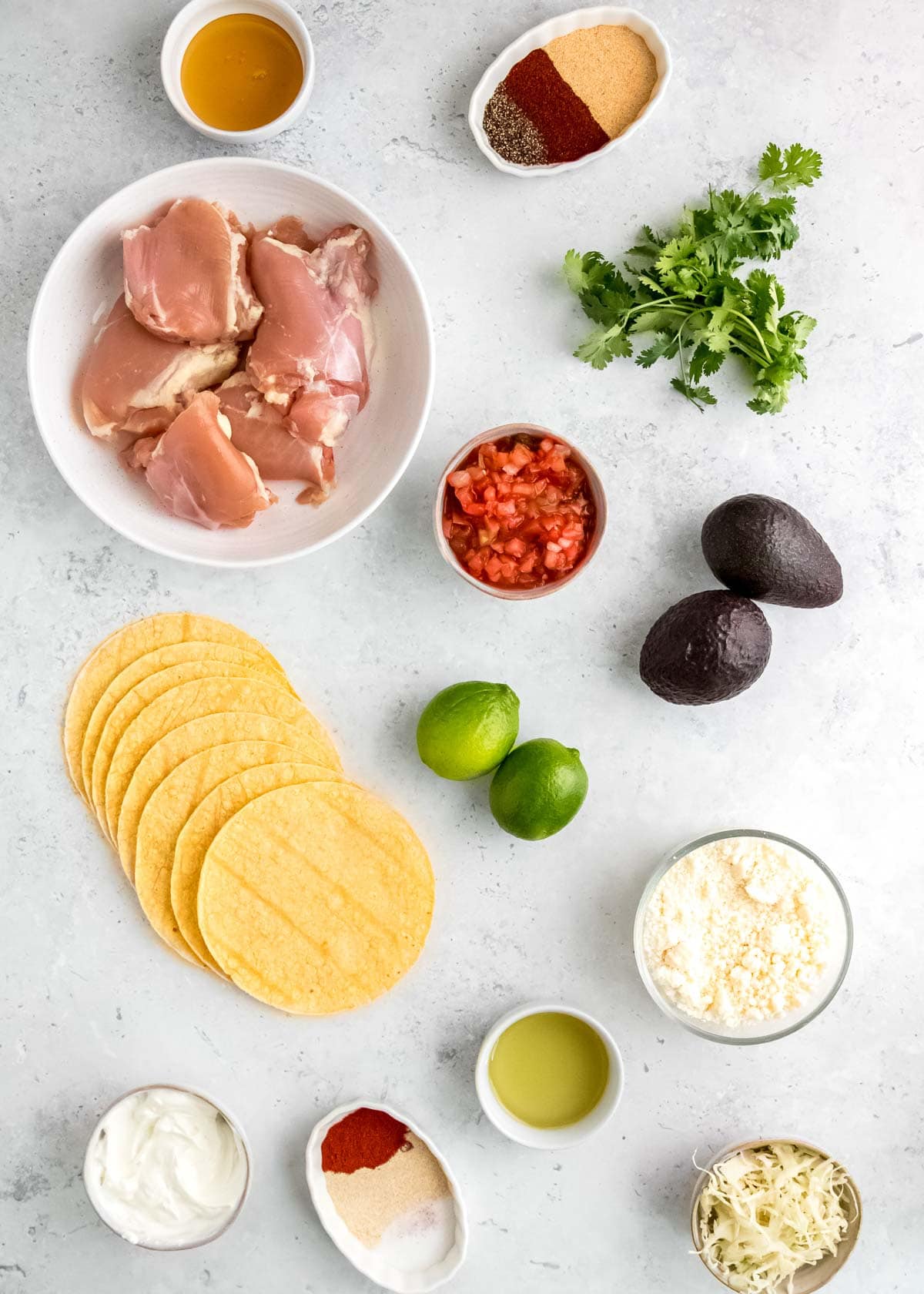 grilled chicken taco ingredients on a white table