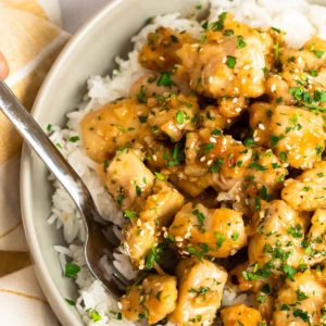 close up, overhead image of honey garlic chicken on white plate