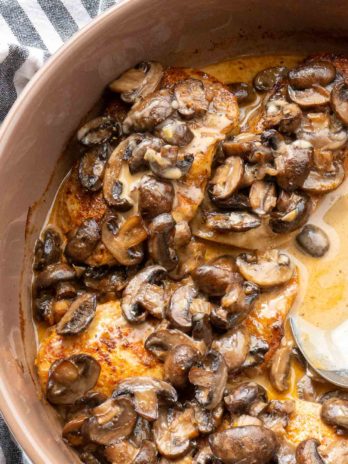 close up overhead image of baked mushroom chicken and spoon