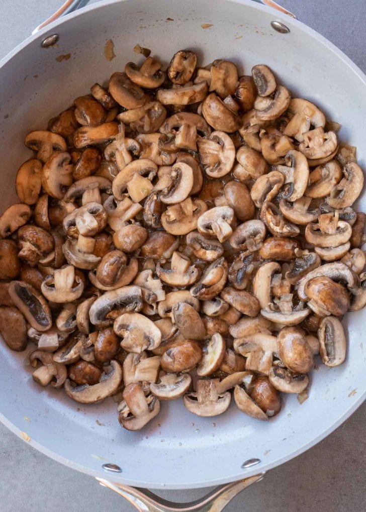 overhead image of sauteed mushrooms in a skillet