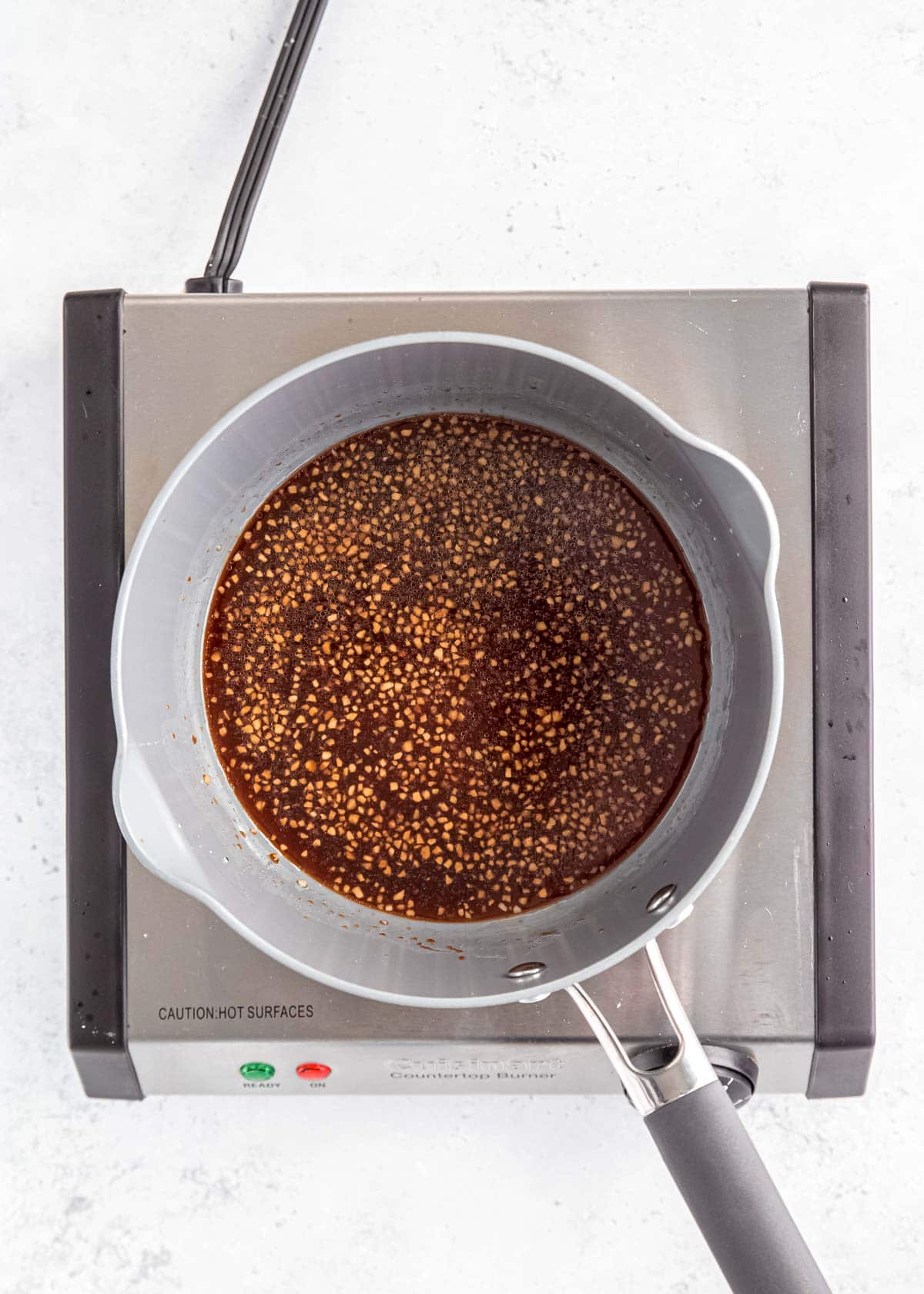 overhead image of sesame sauce in gray pot