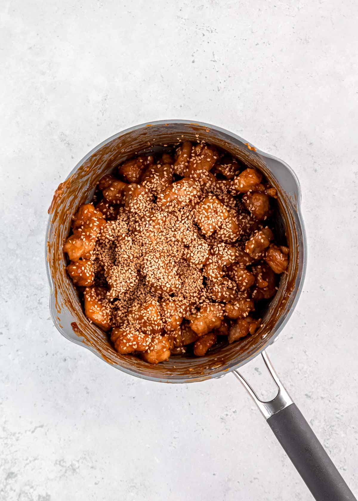 sesame chicken in a gray pot 