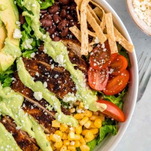 close up image of southwest chicken and dressing in white bowl