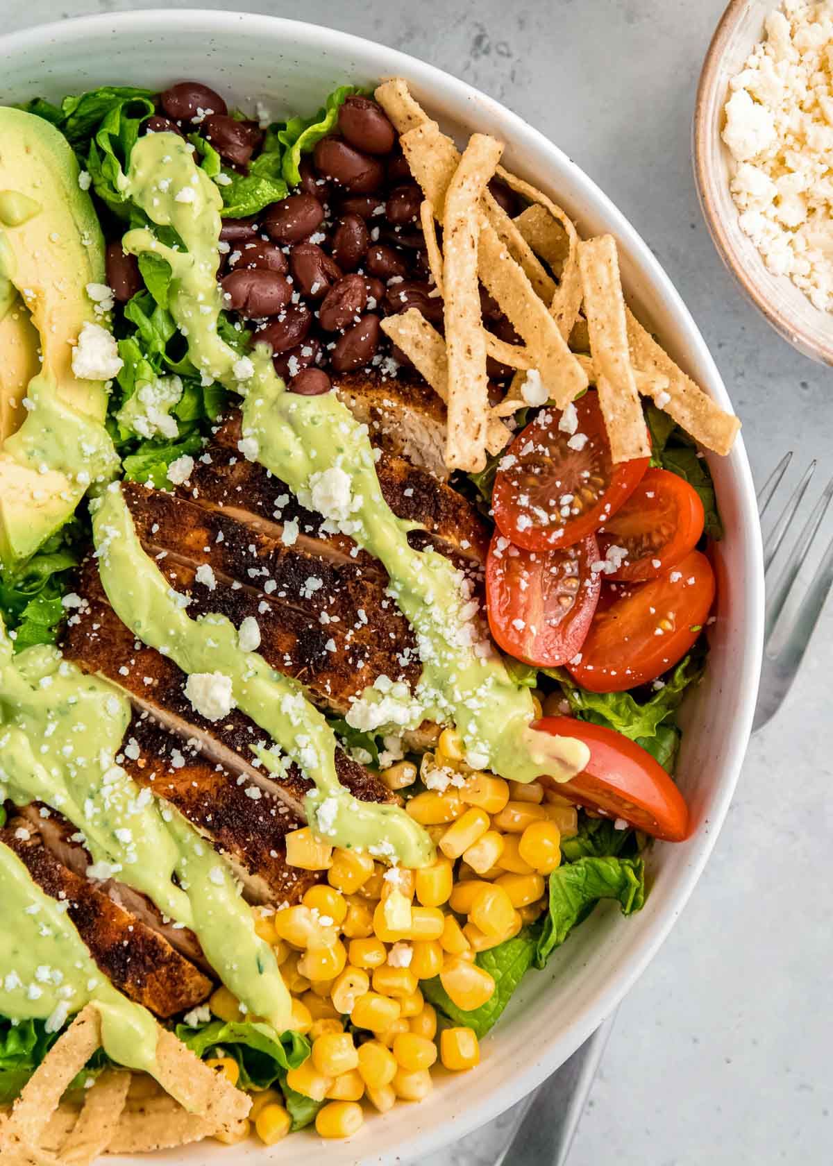 close up image of southwest chicken and dressing in white bowl