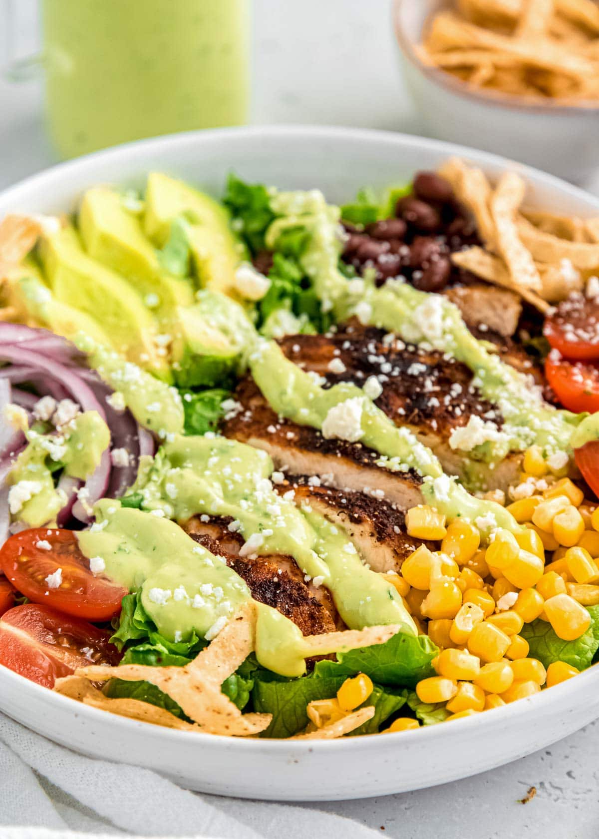 close up image of southwest chicken salad in white bowl