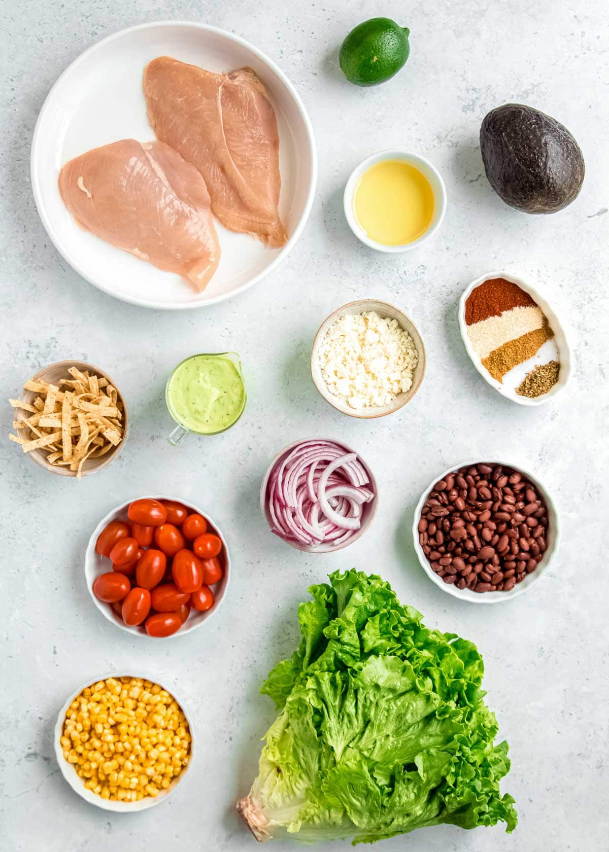 overhead image of southwest chicken salad ingredients on a white table 