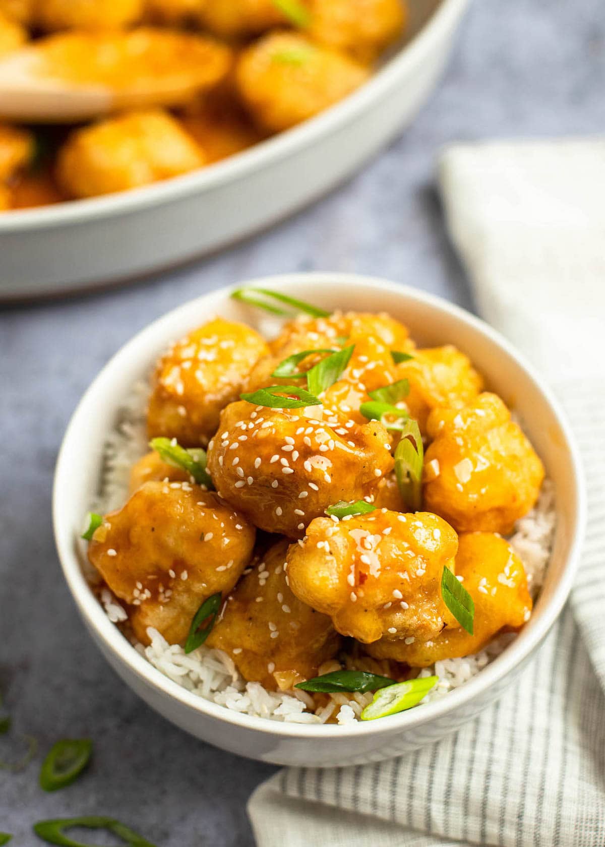 overhead image of sweet and sour chicken in white bowl