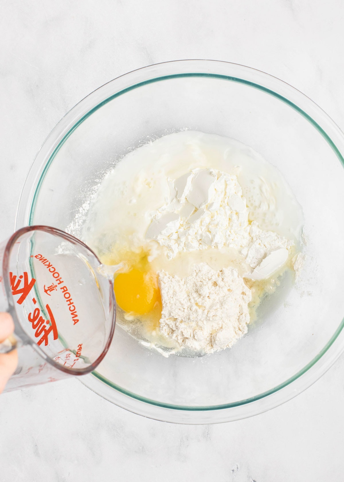 flour and egg in clear mixing bowl