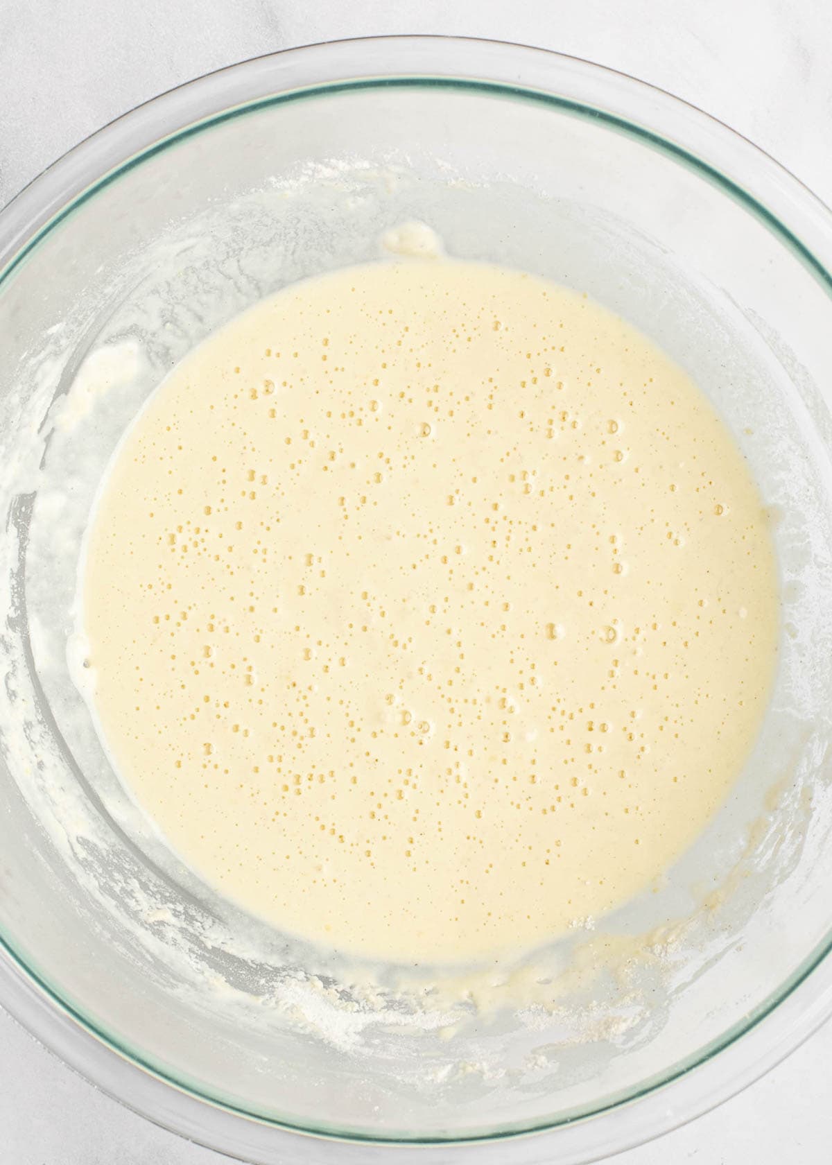 batter being mixed in clear mixing bowl