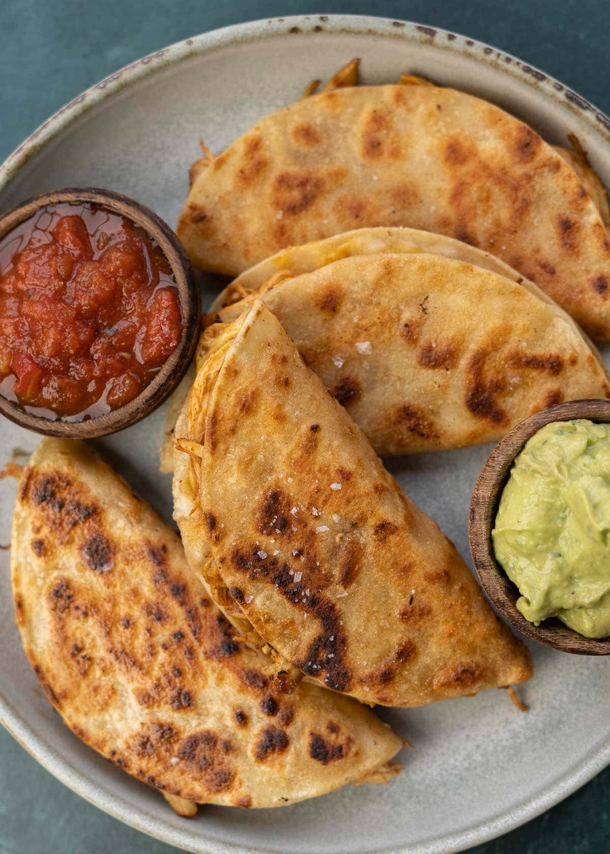 overhead image of stacked chicken tacos on plate