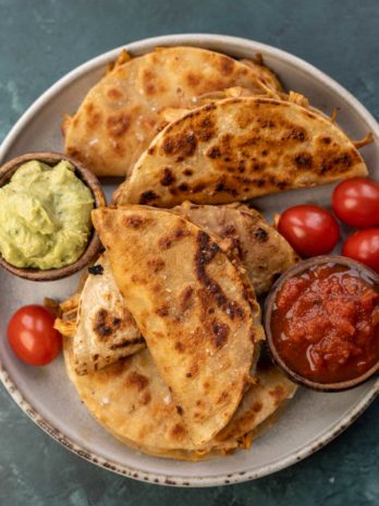 overhead image of salsa, avocado, and chicken tacos on plate