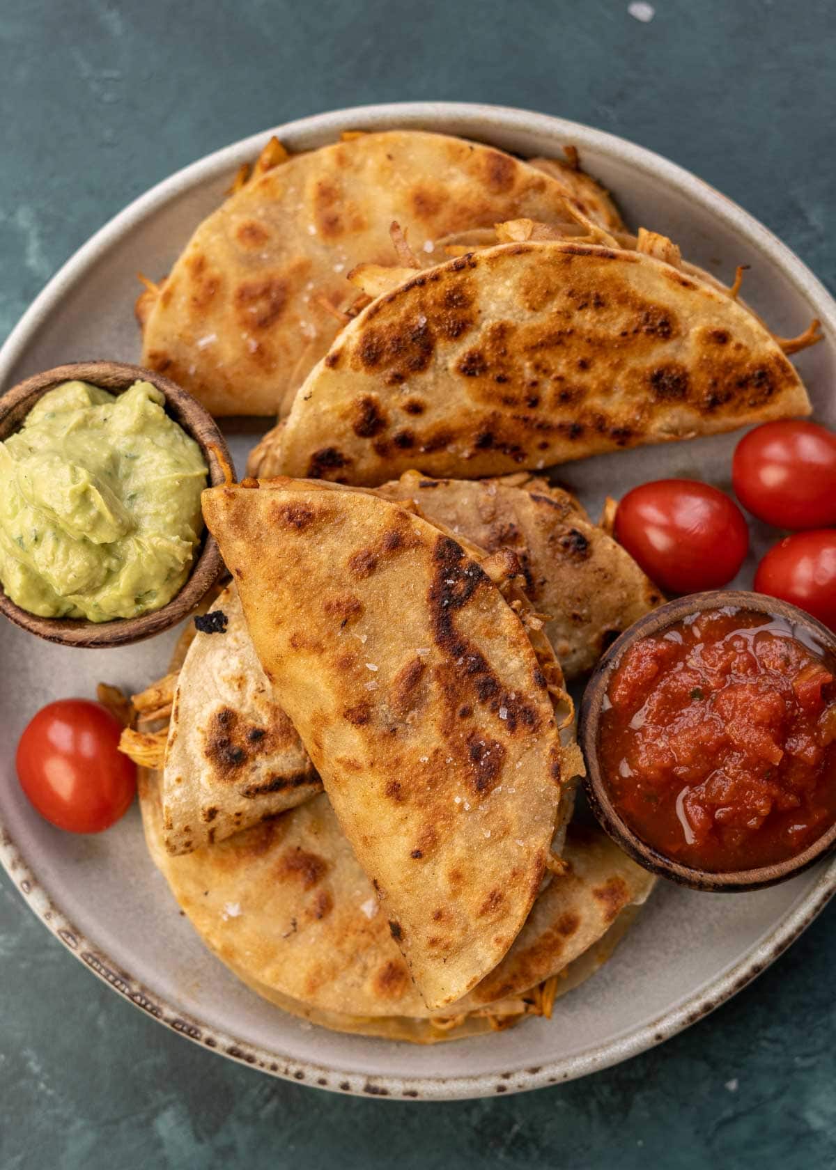 overhead image of salsa, avocado, and chicken tacos on plate